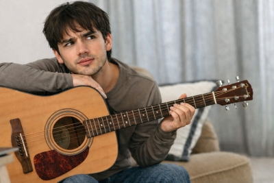Guitarist studying the fretboard while playing